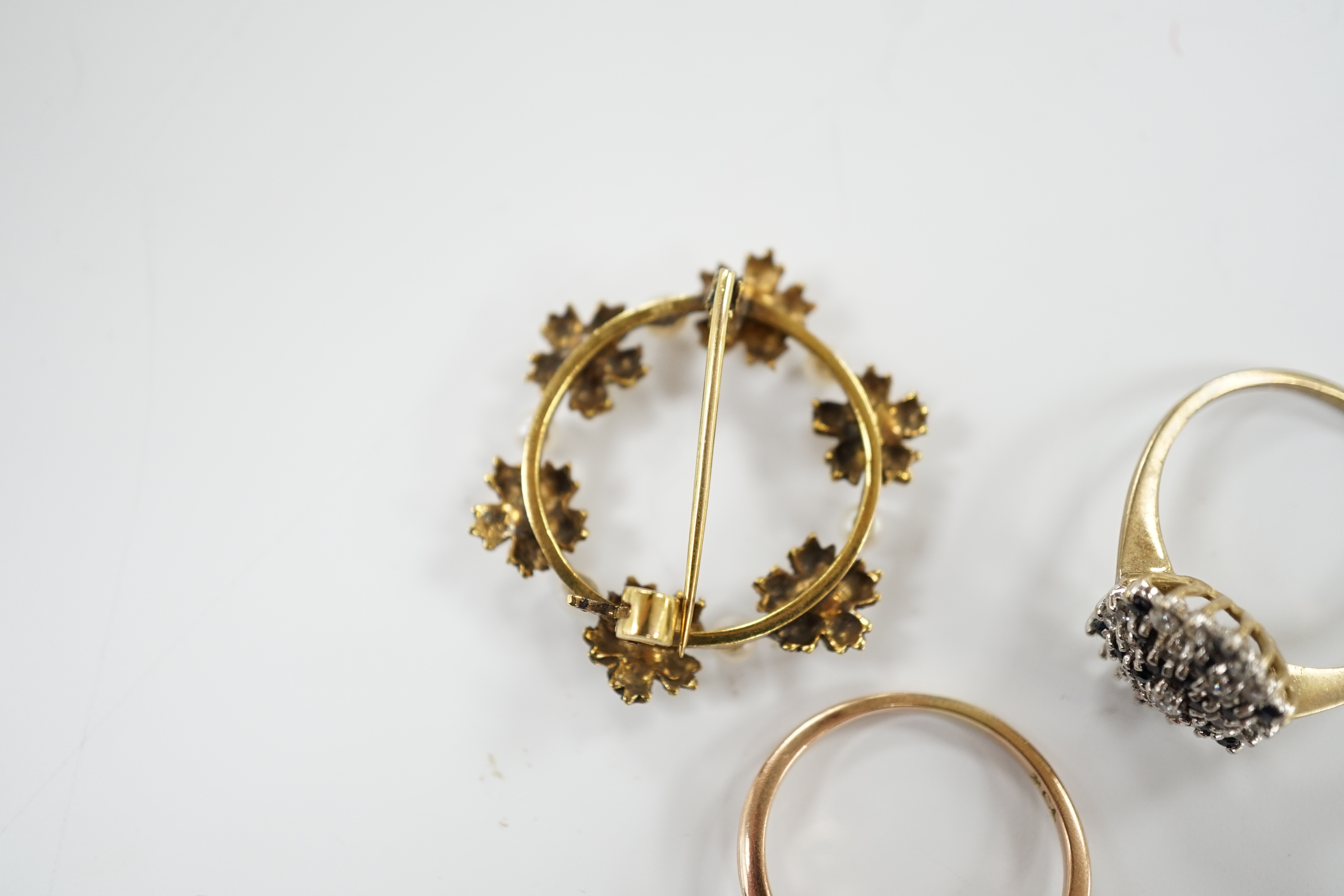 A 9ct gold and two colour sapphire cluster set dress ring, one other 9ct and opal ring and a 9ct gold and cultured pearl set open work circular brooch, gross weight 8.5 grams.